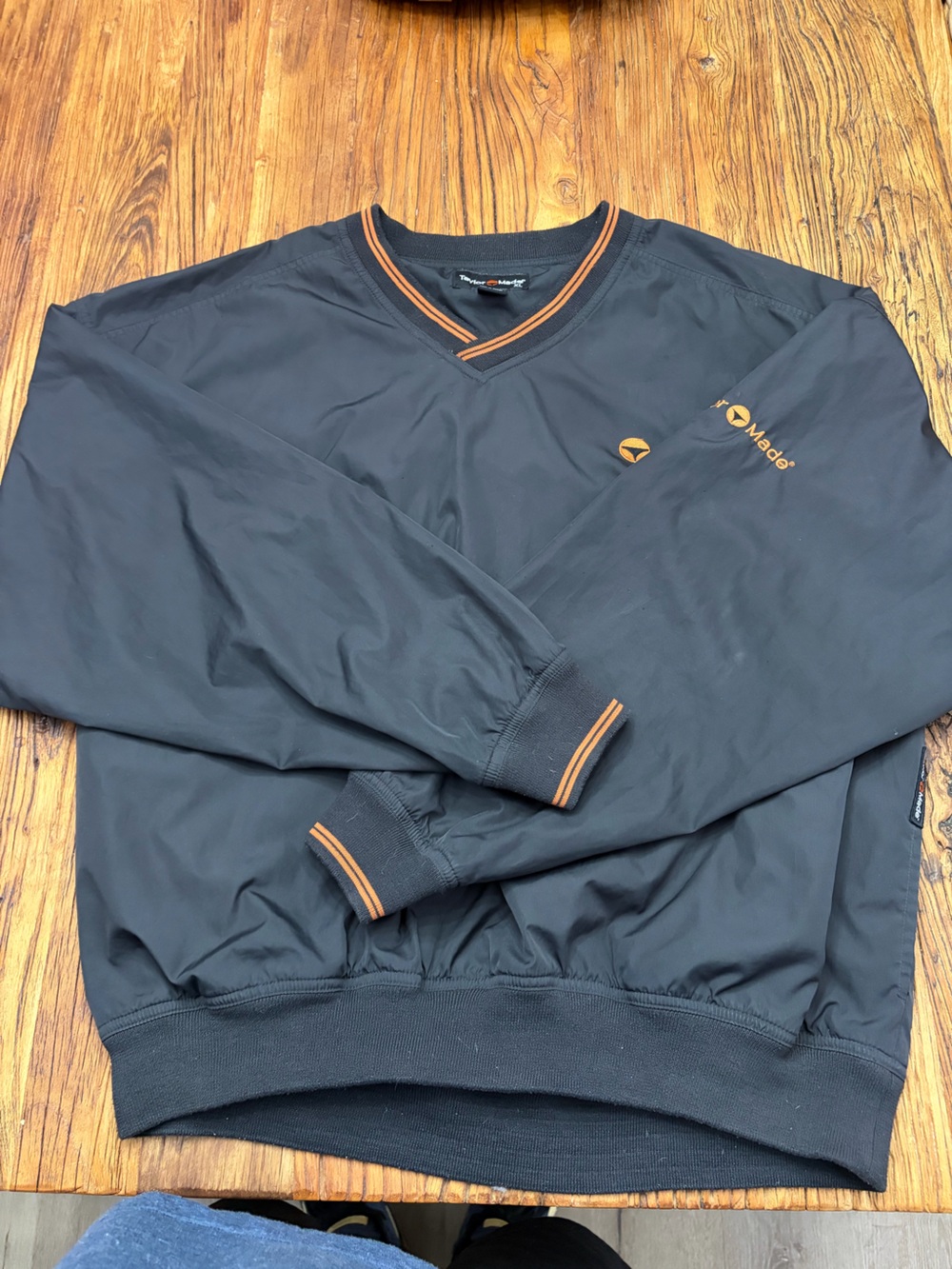 Vintage TaylorMade V-neck black sweater with orange trim. It is size men’s XL.